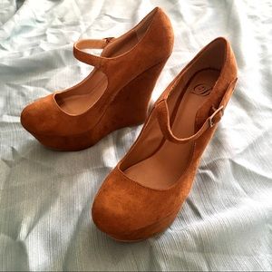 Brown wedges with an ankle strap.
